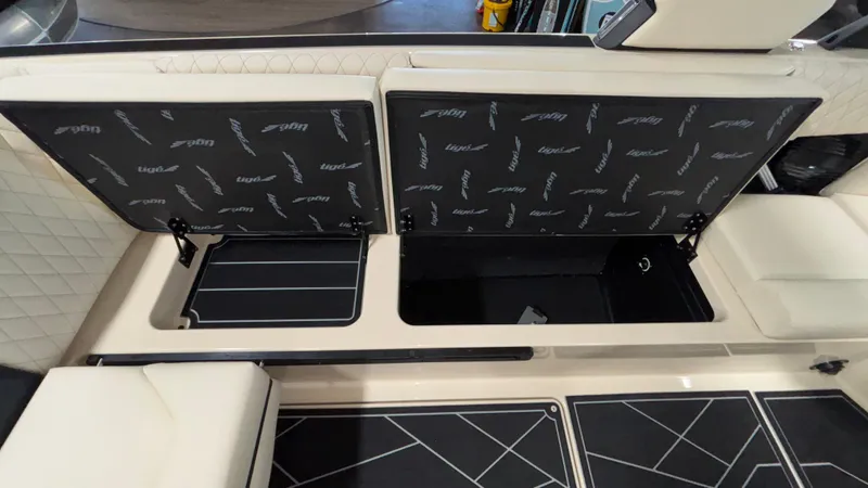 Slide: The Image of 2025 Tigé Z5 boat storage compartments with open lids, showcasing interior design and seating. - 17