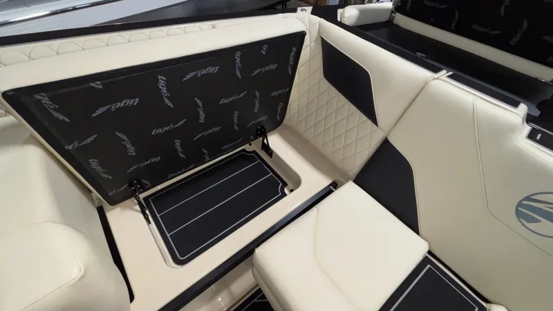 Slide: The Image of 2025 Tigé Z5 boat interior with open storage compartment and quilted seating. - 19