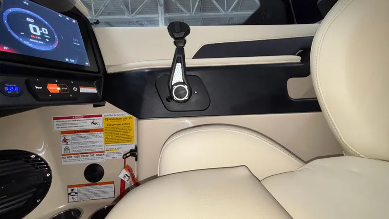 Slide: The Image of 2025 Tigé Z5 boat interior with dashboard, controls, and beige seating. - 26