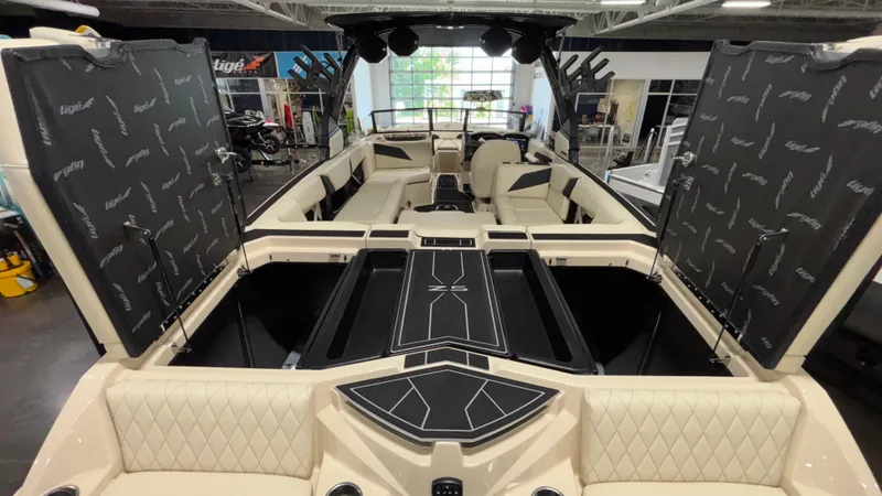 Slide: The Image of 2025 Tigé Z5 boat interior with open storage compartments and luxurious seating. - 29