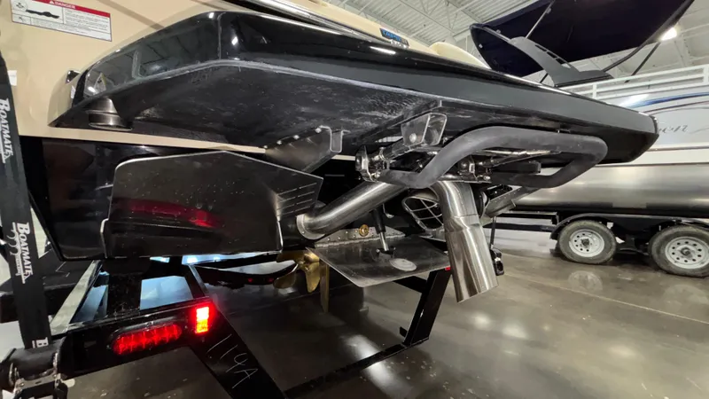 Slide: The Image of 2025 Tigé Z5 boat underside with exhaust and propeller details in showroom. - 3