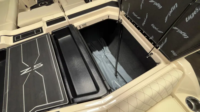 Slide: The Image of 2025 Tigé Z5 boat storage compartment with open lid, showcasing spacious interior. - 31