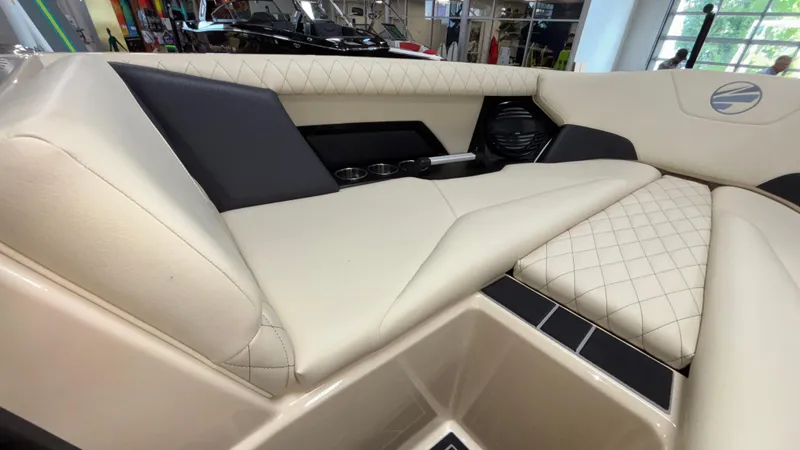 Slide: The Image of 2025 Tigé Z5 boat interior with beige quilted seating and cup holders. - 35