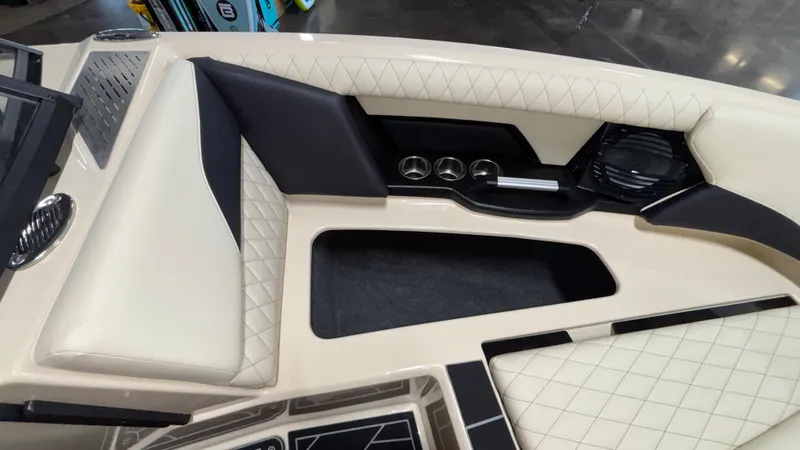 Slide: The Image of 2025 Tigé Z5 boat interior with beige quilted seating and cup holders. - 37
