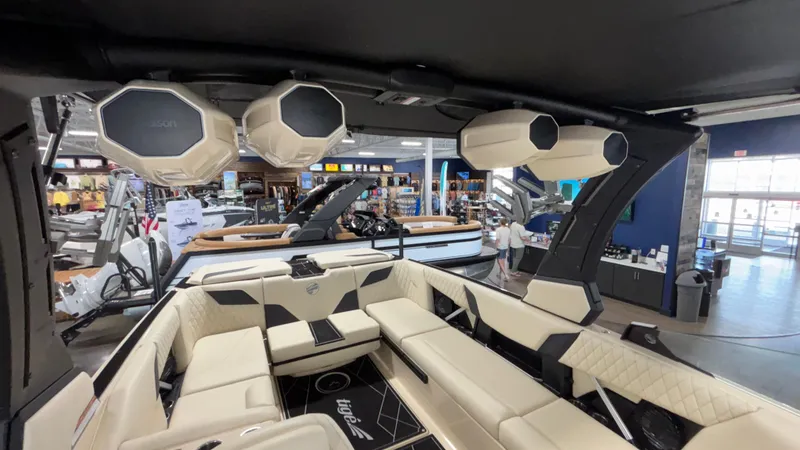 Slide: The Image of 2025 Tigé Z5 boat interior with luxury seating and advanced audio system in showroom. - 43