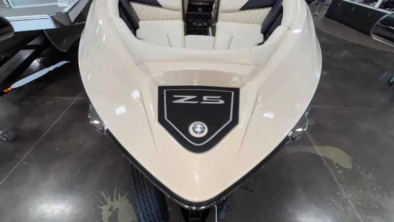 Slide: The Image of 2025 Tigé Z5 boat, beige exterior, luxury seating, showroom display. - 44