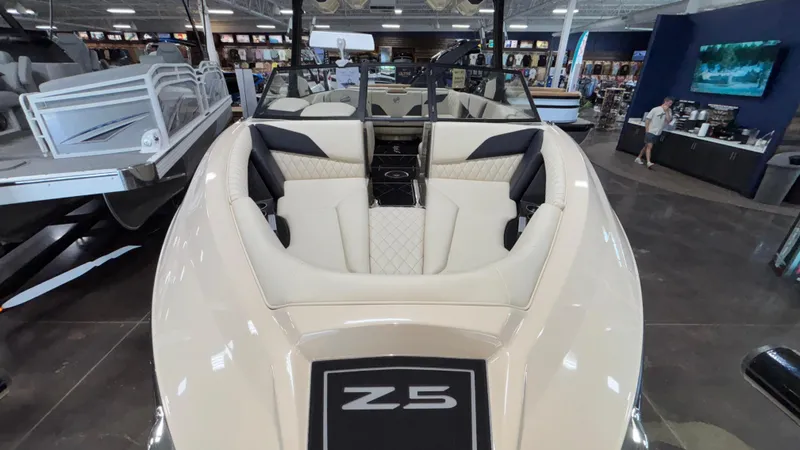 Slide: The Image of 2025 Tigé Z5 boat interior with luxurious seating in showroom. - 45