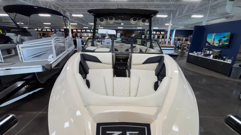 Slide: The Image of 2025 Tigé Z5 boat interior with luxurious seating in a showroom. - 46