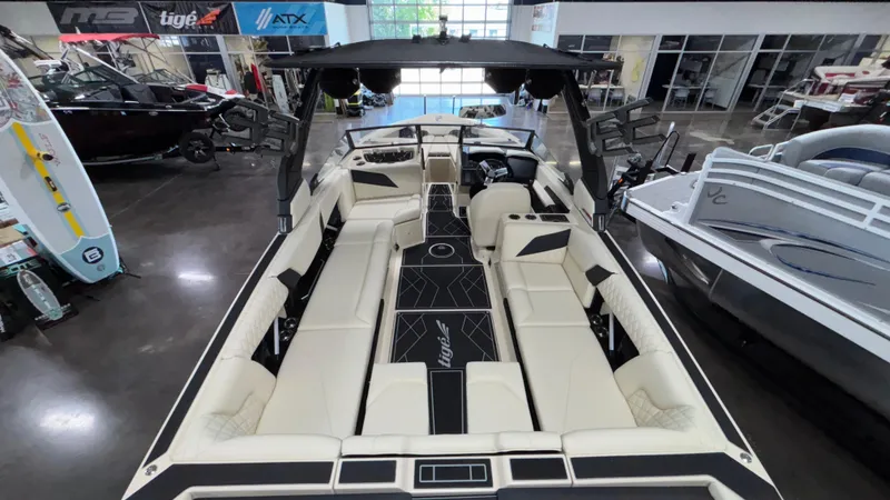 Slide: The Image of 2025 Tigé Z5 boat interior with luxurious seating and modern design in showroom. - 8
