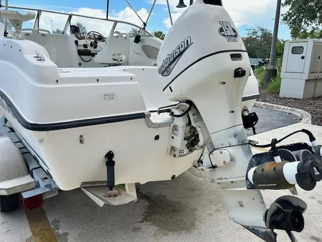 Slide: The Image of 2002 Sea Pro 200 Family Fish boat with Johnson outboard motor, parked on a trailer. - 4