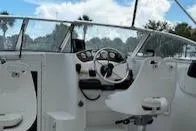 Slide: The Image of 2002 Sea Pro 200 Family Fish boat interior with steering wheel and seating. - 7