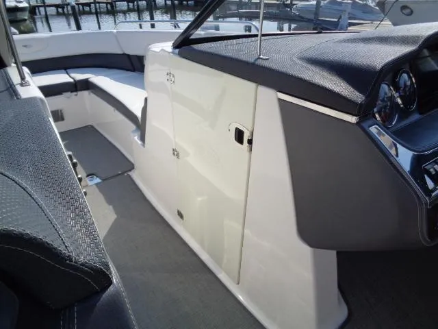 Slide: The Image of 2015 Chaparral 307 SSX boat interior with sleek seating and modern dashboard design. - 10