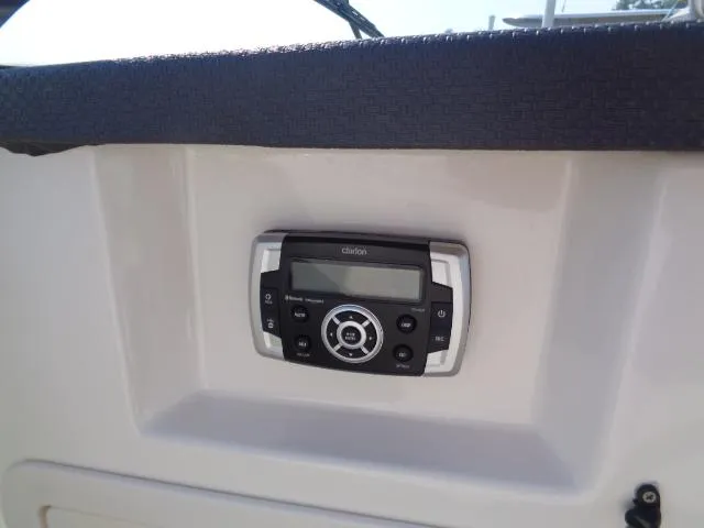 Slide: The Image of Clarion stereo system on 2015 Chaparral 307 SSX boat dashboard. - 12
