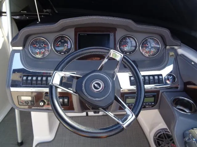 Slide: The Image of Dashboard of 2015 Chaparral 307 SSX boat with steering wheel and gauges. - 13