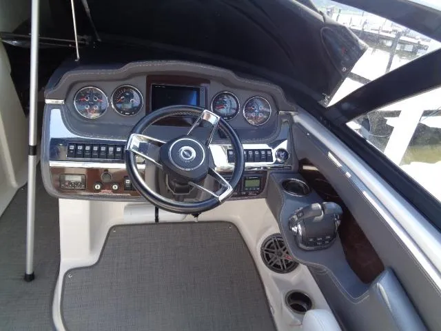 Slide: The Image of Cockpit of 2015 Chaparral 307 SSX boat with steering wheel and control panel. - 14