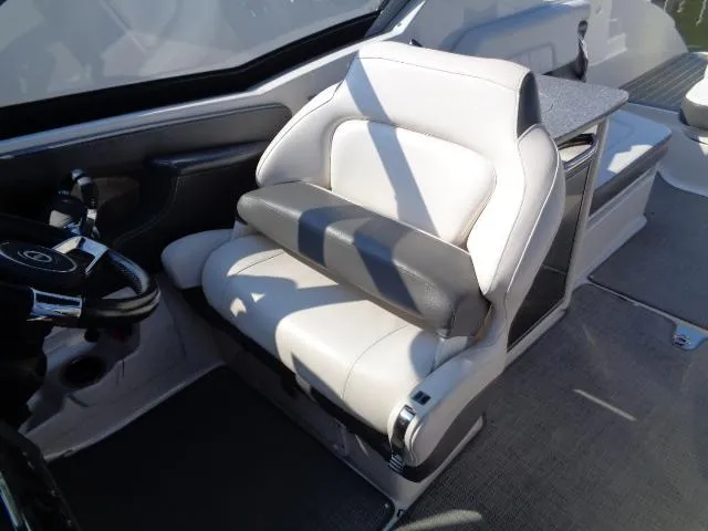 Slide: The Image of Captain's seat in 2015 Chaparral 307 SSX boat, featuring sleek design and comfortable upholstery. - 16