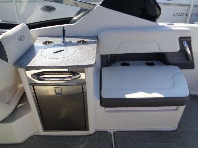 Slide: The Image of 2015 Chaparral 307 SSX boat interior with seating and kitchenette area. - 21