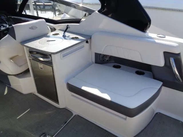 Slide: The Image of 2015 Chaparral 307 SSX boat interior with seating and kitchenette area. - 23