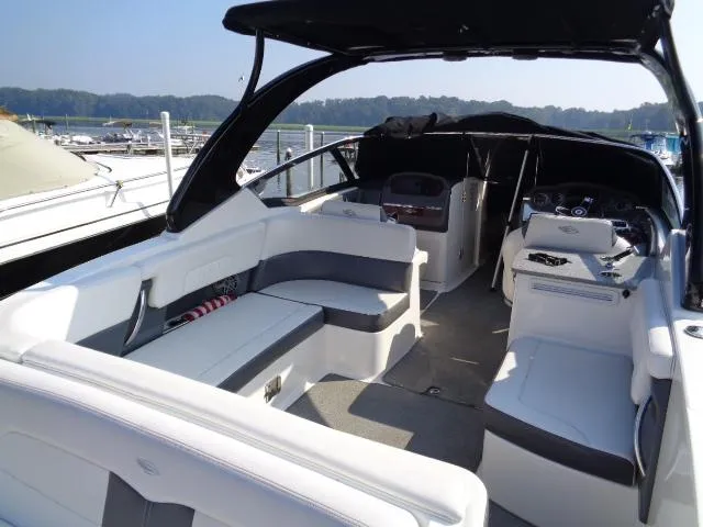 Slide: The Image of 2015 Chaparral 307 SSX boat interior with seating and helm, docked at marina. - 25