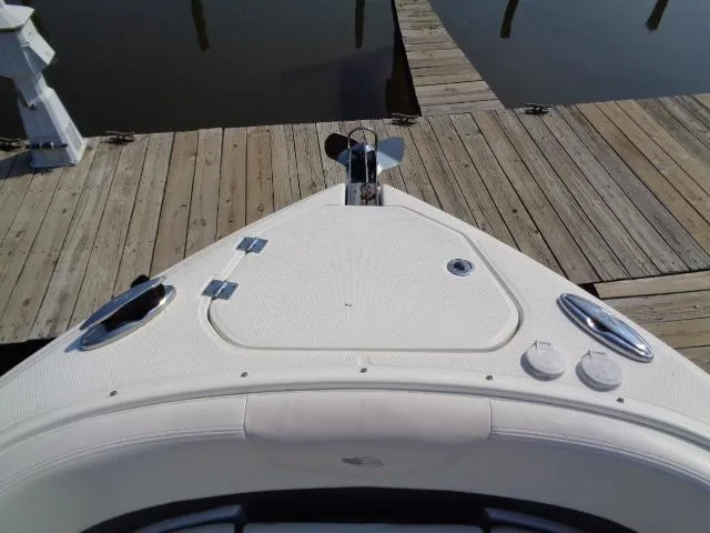 Slide: The Image of 2015 Chaparral 307 SSX boat bow at dock, featuring sleek design and fittings. - 4