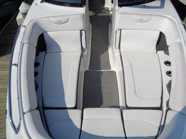 Slide: The Image of 2015 Chaparral 307 SSX boat interior with white seating and gray flooring. - 7