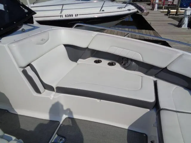 Slide: The Image of 2015 Chaparral 307 SSX boat interior with white seating and cup holders. - 9
