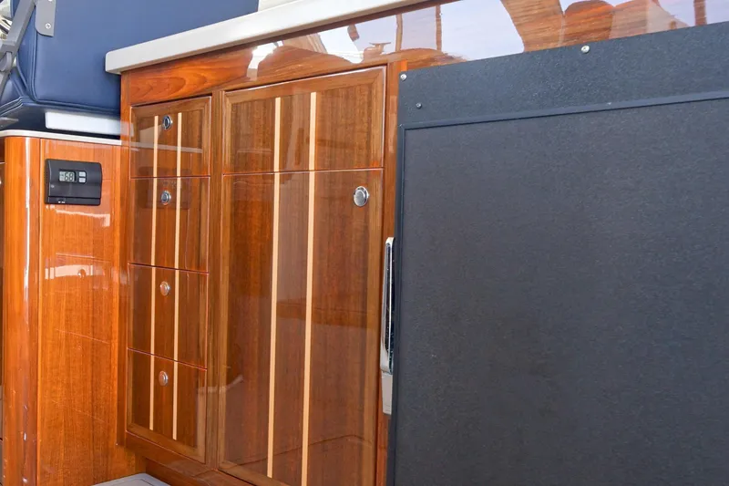 Slide: The Image of Luxurious wood cabinetry inside a 2016 Lindell Ocean Roamer boat interior. - 10