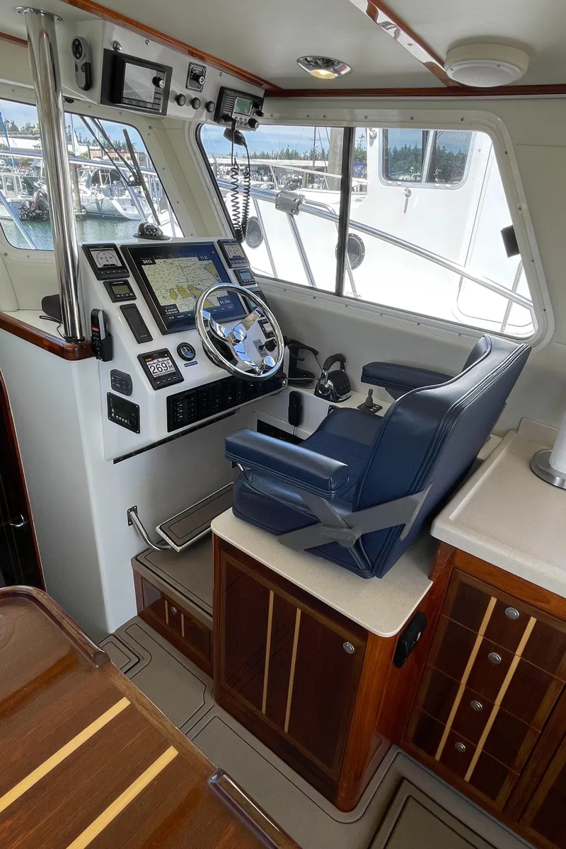 Slide: The Image of 2016 Lindell Ocean Roamer helm with navigation equipment and blue captain's chair. - 12