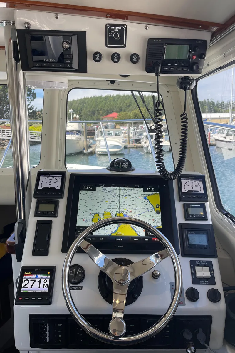 Slide: The Image of Control panel of a 2016 Lindell Ocean Roamer boat with navigation equipment and steering wheel. - 14