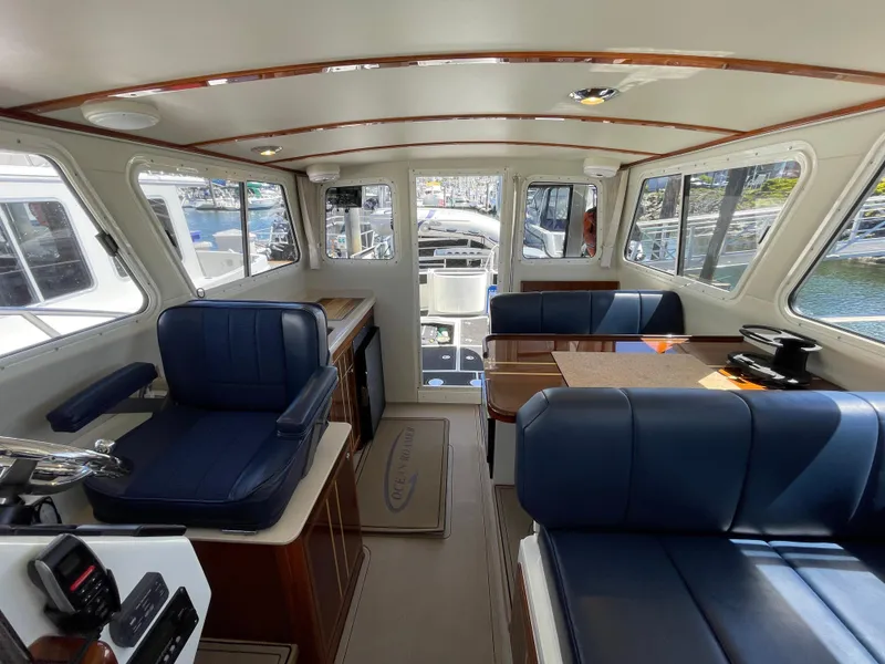 Slide: The Image of Interior of 2016 Lindell Ocean Roamer boat with blue seating and wooden accents. - 17