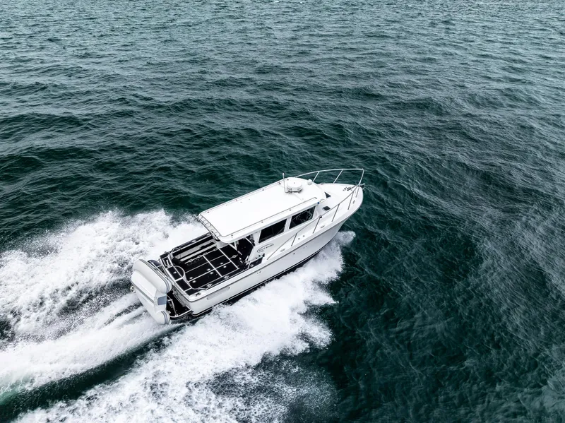 Slide: The Image of 2016 Lindell Ocean Roamer cruising on open water, aerial view. - 2