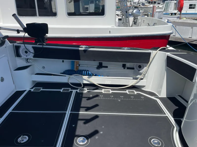 Slide: The Image of 2016 Lindell Ocean Roamer boat deck with fishing equipment and storage compartments. - 28