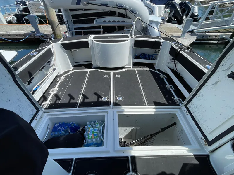 Slide: The Image of 2016 Lindell Ocean Roamer boat deck with storage compartments and fishing gear. - 31