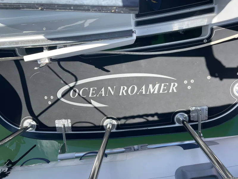 Slide: The Image of Lindell Ocean Roamer 2016 boat deck with logo and metal railings. - 34
