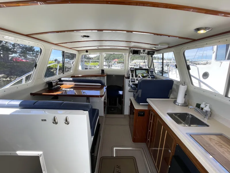 Slide: The Image of Interior of 2016 Lindell Ocean Roamer boat with seating, table, and helm. - 5