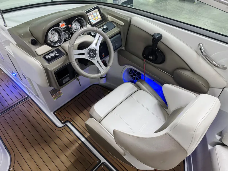Slide: The Image of 2016 Crownline 270 SS boat cockpit with steering wheel, gauges, and comfortable seating. - 10