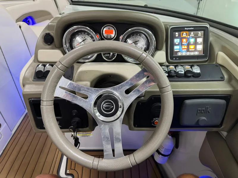 Slide: The Image of Steering wheel and dashboard of 2016 Crownline 270 SS boat with gauges and touchscreen display. - 14