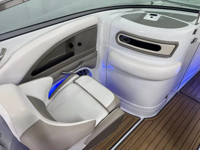 Slide: The Image of 2016 Crownline 270 SS boat interior with white seating and blue accent lighting. - 16