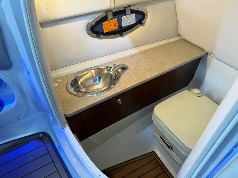Slide: The Image of 2016 Crownline 270 SS boat bathroom with sink and toilet, featuring modern design. - 19