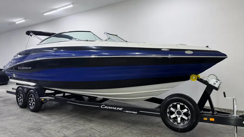 Slide: The Image of 2016 Crownline 270 SS boat on trailer in indoor showroom. - 2