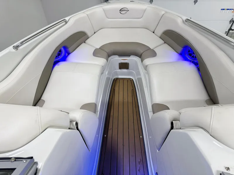 Slide: The Image of 2016 Crownline 270 SS boat interior with white seating and blue LED lighting. - 21
