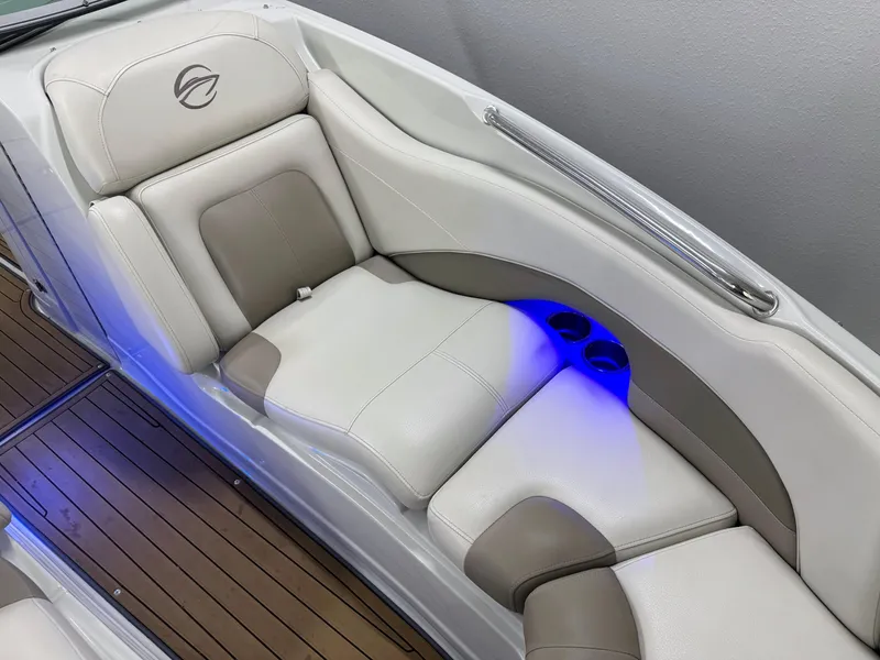 Slide: The Image of 2016 Crownline 270 SS boat interior with white leather seating and blue LED lighting. - 22