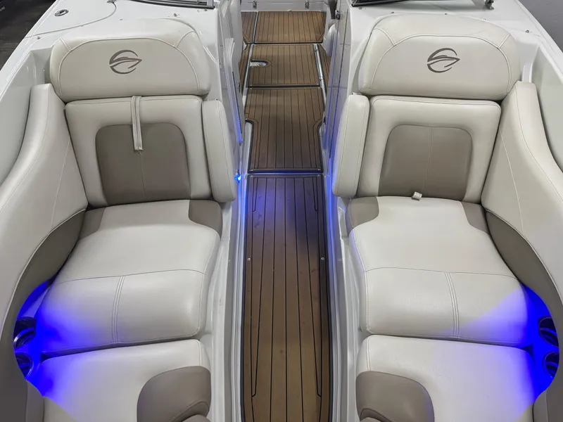 Slide: The Image of 2016 Crownline 270 SS boat interior with white leather seats and blue LED lighting. - 24