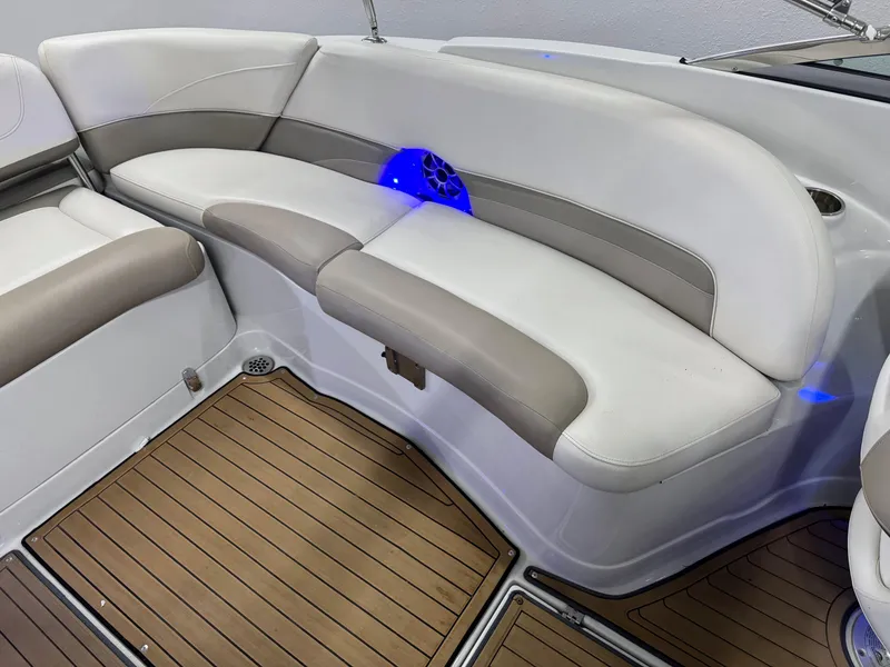 Slide: The Image of 2016 Crownline 270 SS boat interior with cushioned seating and wood-style flooring. - 25