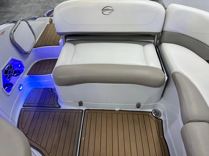 Slide: The Image of 2016 Crownline 270 SS boat interior with cushioned seating and blue LED lighting. - 26