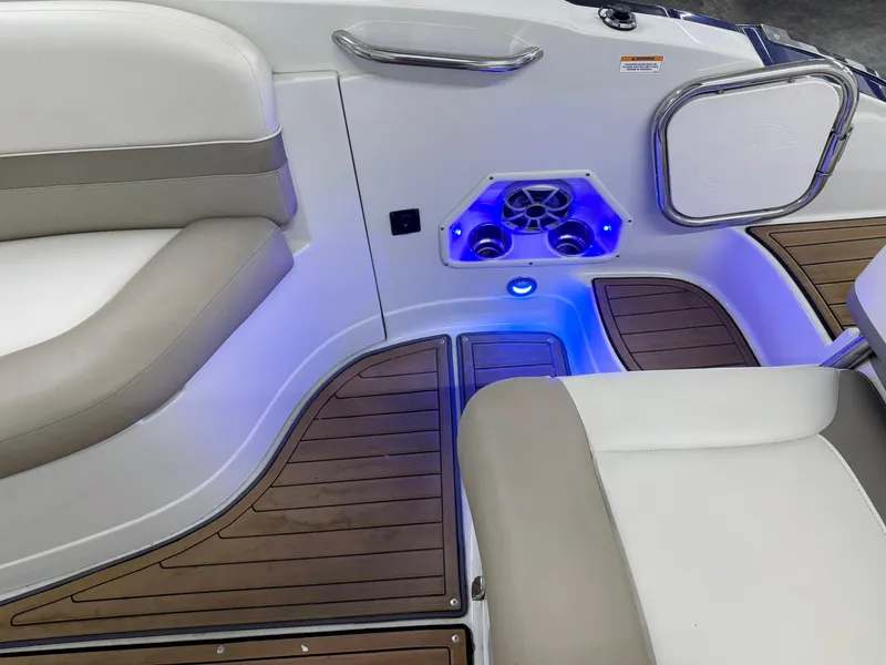 Slide: The Image of Interior of 2016 Crownline 270 SS boat with cushioned seating and blue LED lighting. - 28