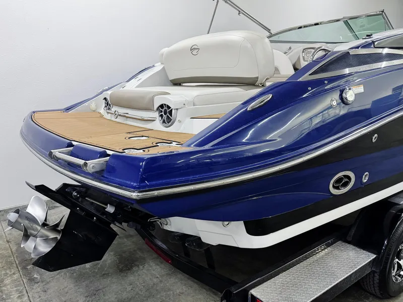 Slide: The Image of 2016 Crownline 270 SS boat, blue exterior, rear view with propeller and seating. - 3