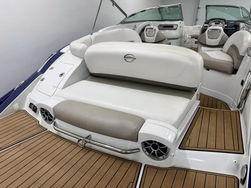 Slide: The Image of 2016 Crownline 270 SS boat interior with white seating and wood-style flooring. - 5