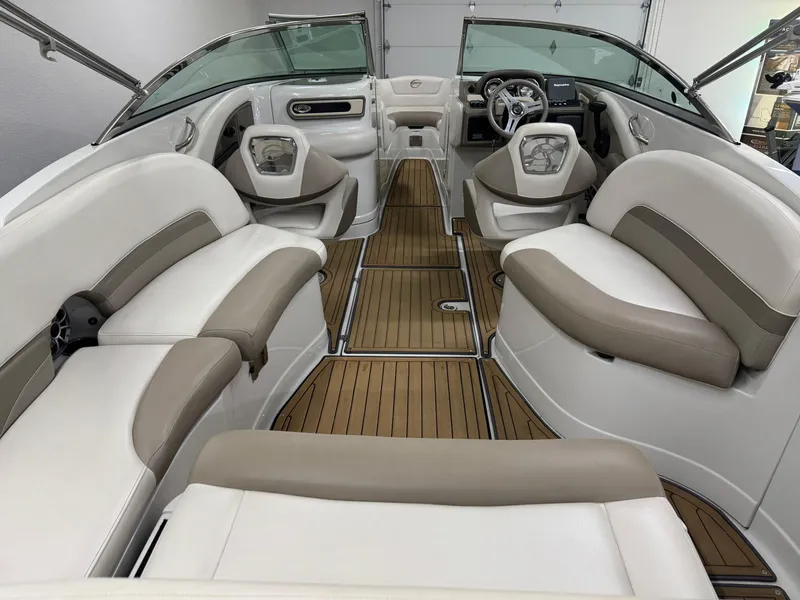 Slide: The Image of 2016 Crownline 270 SS boat interior with beige seating and wood-style flooring. - 7