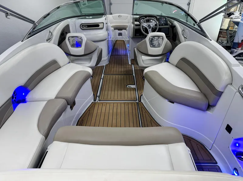 Slide: The Image of 2016 Crownline 270 SS boat interior with white and beige seating, blue LED lighting. - 8